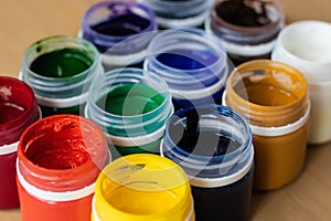 Paint brushes and watercolor paints,  tempera paints on the table in a workshop