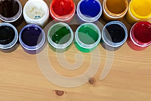 Paint brushes and watercolor paints,  tempera paints on the table in a workshop