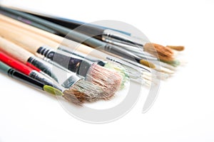 Paint brushes on white background with selective focus