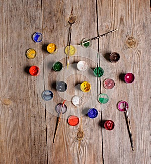 paint and brushes on the wooden background