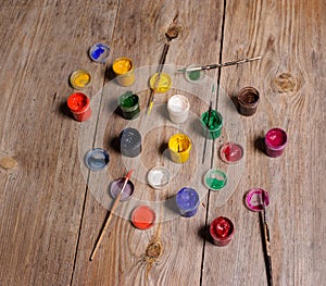 paint and brushes on the wooden background