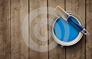 Paint can on the wooden background