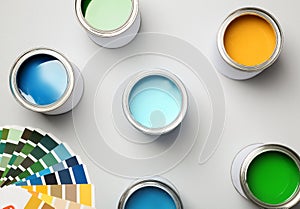 Paint cans and color palette on white background