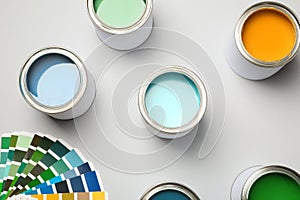 Paint cans and color palette on white background