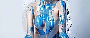 paint drips from the woman body, blue liquid drops on beautiful model girl`s body, creative abstract