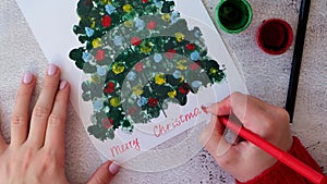 Paint with fingers Merry Christmas tree. DIY Making greeting card Handmade crafts on holiday for children. Step by step