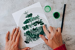 Paint with fingers Merry Christmas tree. Step by step. Happy New Year xmas tree decoration DIY Making greeting card