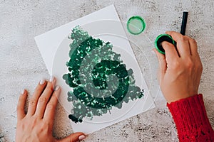 Paint with fingers Merry Christmas tree. Step by step. Happy New Year xmas tree decoration DIY Making greeting card