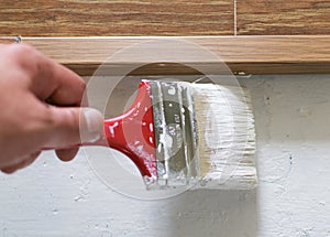 Paint the floor using a paintbrush.