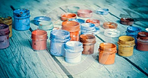 paint jars on a wooden surface