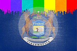 Paint rainbow flag is dripping over the state flag of Michigan