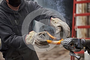 Paint removal: man using steel wool over a bike fork after using a blowtorch