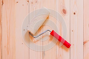 Paint roller brush on wood background