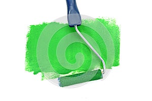 Paint roller leaving stroke of brown green over a white