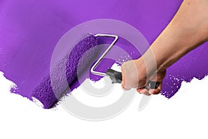 Paint Roller with Purple Over White Wall