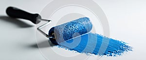 The paint roller with vibrant blue paint on a clean surface AI generated image