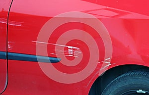 Paint scratches on a red car. Accidental damage to a red car