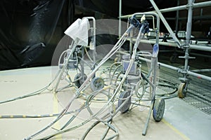 Paint sprayers and equipment waiting for use at a construction site during midday hours