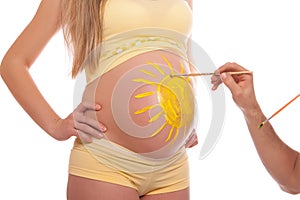 Paint the sun on a pregnant belly