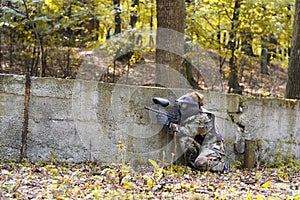 Paintball girl behind wall