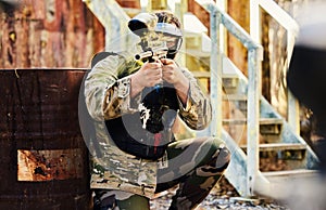 Paintball, military or man with gun in shooting game playing with on fun battlefield mission. Target, warrior or focused
