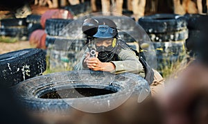 Paintball, person aim gun at target and military tactics, shooting range and war game for sports outdoor. Soldier with