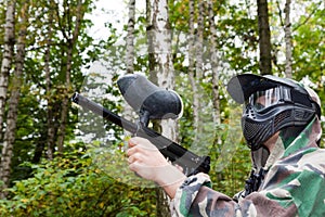 Paintball player shoots aside in forest