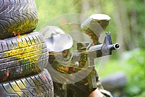 Paintball player under gunfire photo