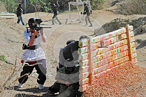 Paintball Players behind Bunker photo