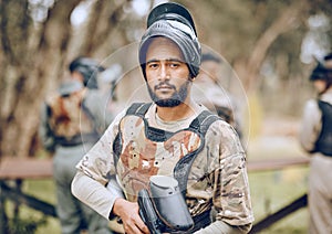 Paintball, sports and portrait of man with gun in woods ready for game, arena match and shooting battle. Training