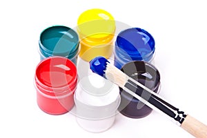 Paintbrush in blue acros acrylic paints