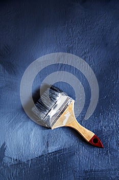 Paintbrush on a blue background with space for text.