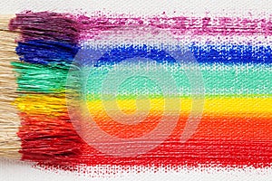 Paintbrush bristle closeup and multicolor rainbow brush strokes