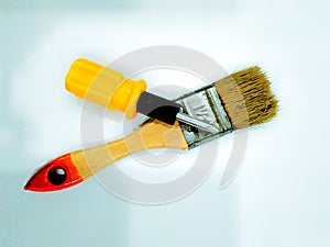 A paintbrush and a minuscule screwdriver that are easy to use everyday