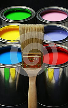 Paintbrush and Paint, Cans of Primary Colored Paints on Black Ba