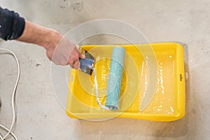 Paintbrush, roller and glue container on concrete surface. Composition tools for home repair and interior renovation