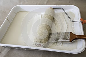 Paintbrush And Roller In Tray