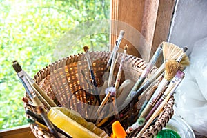 Paintbrushes in black holder cup on Table