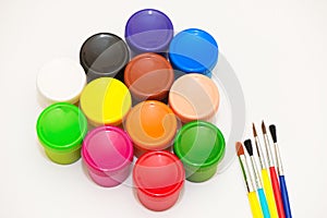 Paintbrushes and gouaches of different colors