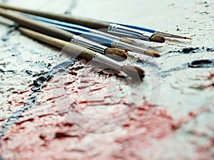 Paintbrushes on oil painting canvas