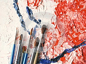 Paintbrushes on oil painting canvas