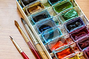 Paintbrushes palette and watercolor paints