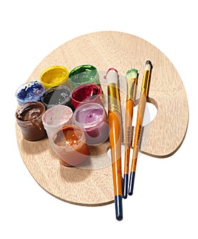 Paintbrushes on wooden palette.