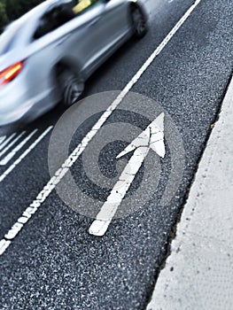 Painted arrow on the street pointing up