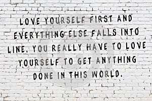 Painted black inscription on white brick wall