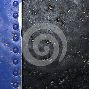 Painted blue metal with rivets on black metal background. 3d