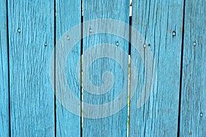 Painted blue old faded wooden planking background with flaws photo