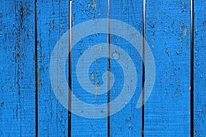 Painted blue wood fence with charred paint