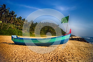 Painted boats of Indian fishermen on beaches of Kerala