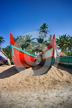 Painted boats of Indian fishermen on beaches of Kerala